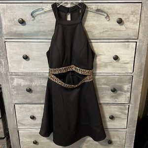 Black and gold cocktail dress with tummy slit